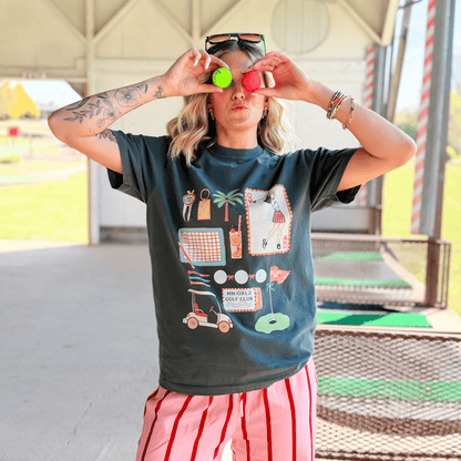 Person wearing a graphic t-shirt with colorful designs outdoors