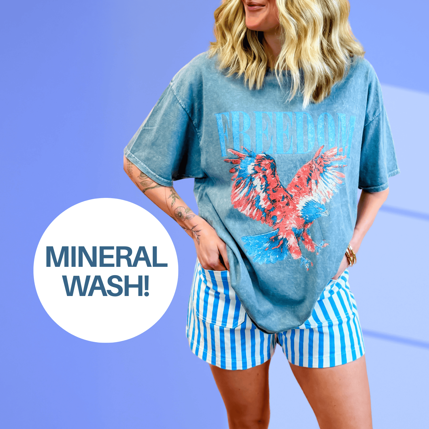 Freedom mineral wash tee in teal with a red eagle graphic, paired with blue and white striped shorts.