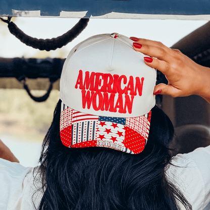 American Woman puff pattern hat with a red and white star design, worn backwards, showing the back view and hair.