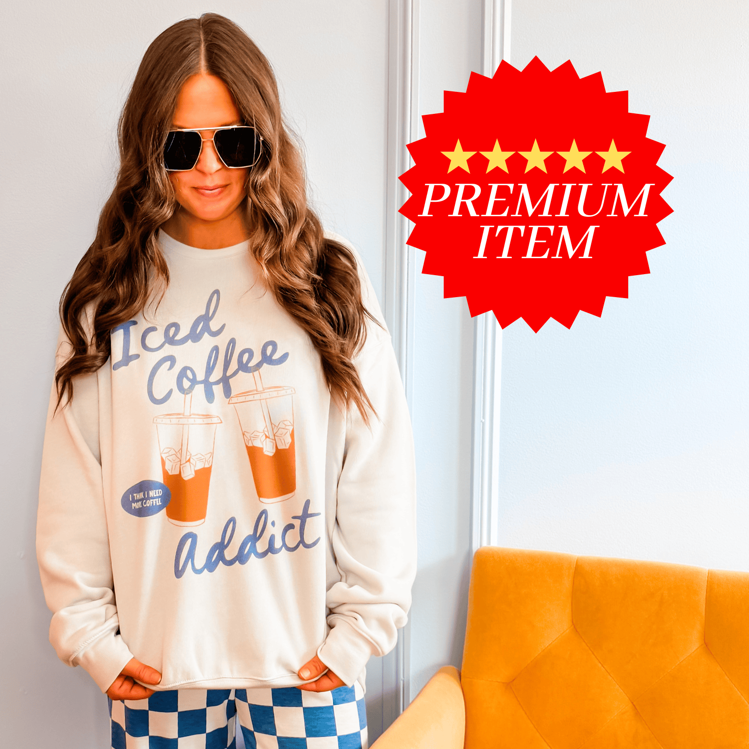 Iced coffee addict sweatshirt in dust color, featuring graphic text and two iced coffee illustrations, worn by a model.