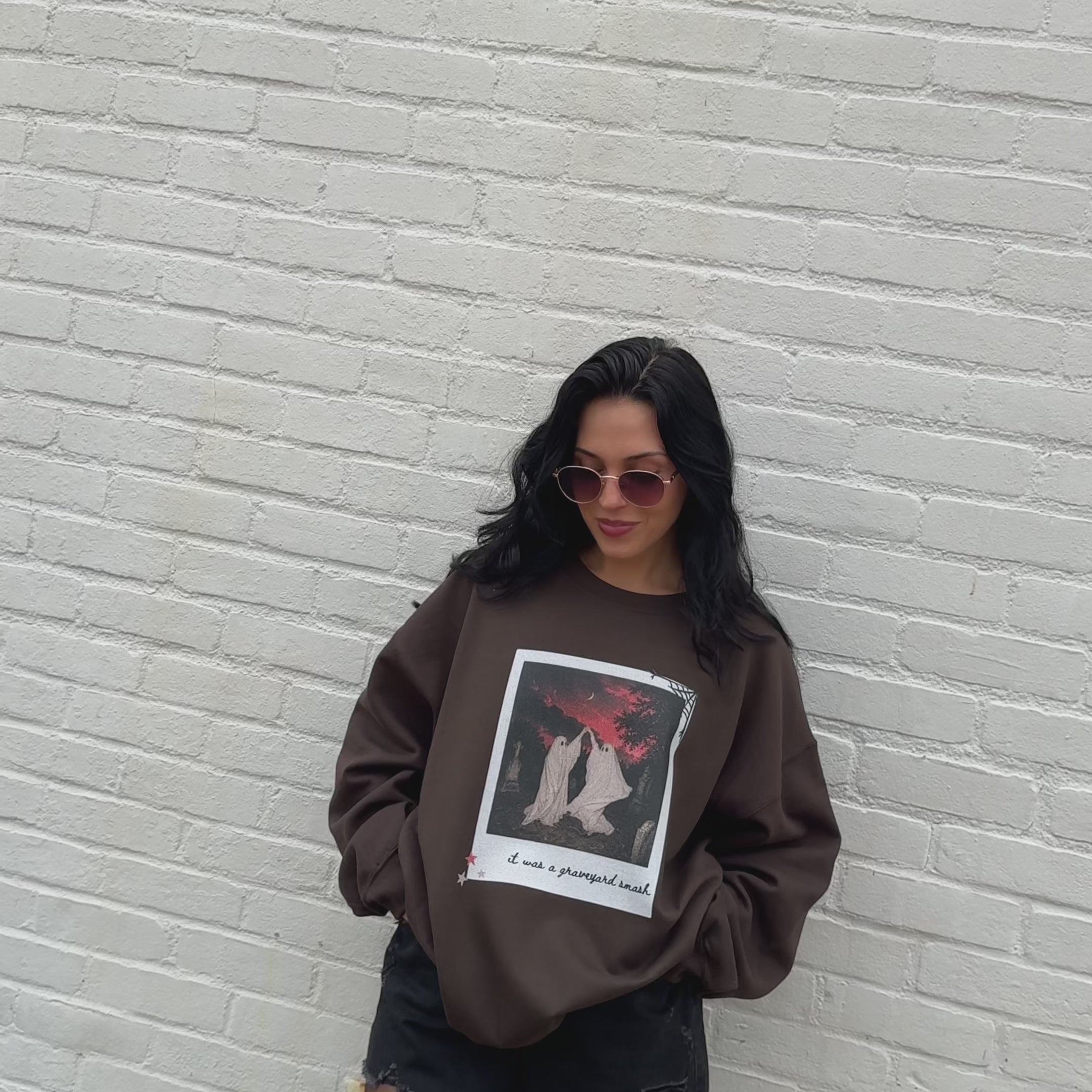 woman wearing graveyard smash sweashirt