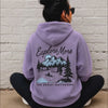 woman wearing explore more hoodie